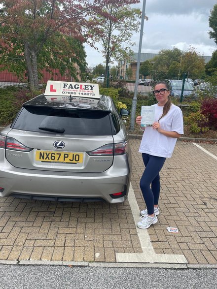 Chloe holding her practical driving test pass certificate in Manningham